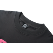 Close-up view of the collar and brand tag on the Sp5der 555 Young Thug streetwear t-shirt in dark grey fabric.