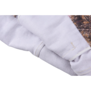 Close-up view of the interior fabric texture and durable construction of the Sp5der Trucker Jacket Real Tree Camo.