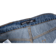 Close-up of the branded Sp5der Vintage Web Jean denim waistband featuring the iconic logo tag and premium stitching.
