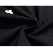 Close-up view of the premium fabric texture on the black Sp5der Worldwide Star Beluga T-shirt featuring a white star.