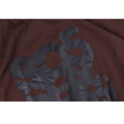 Close-up of the brown Sp5der Sp5 Sex graphic t-shirt, highlighting the provocative streetwear design and quality fabric.