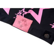 Sp5der 5 Star Trucker Jacket featuring a pink graphic tag detail and bold star print on black durable fabric.