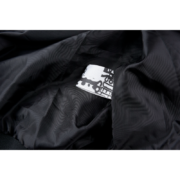 Detailed view of the interior brand label and premium satin fabric on the black Sp5der Satin Bomber Jacket.