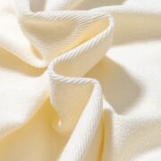 Close up view of the premium cream fabric texture from the Sp5der x Mariah the Scientist Scorpion sweatpants.