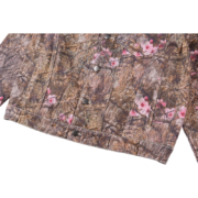 Front view of the Sp5der Trucker Jacket in Real Tree Camo featuring durable construction and iconic button closures.
