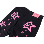 Back view of black Sp5der 5Star Vintage 501 Denim jeans with pink star graphics and a branded patch on the waistband.