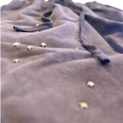 Close-up detail of the brown Sp5der x Cactus Jack Rodeo shorts featuring embroidered star embellishments and a drawstring.