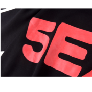 Close up view of the bright red 5EX Sp5der logo branding printed on a soft black fabric hoodie from our collection.