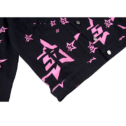 Black Sp5der trucker jacket featuring a bold pink five-star graphic pattern and iconic streetwear design elements.