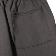 Detail view of the pocket on the Jet-Black Sp5der Beluga sweatpants, showcasing the premium fabric and design.