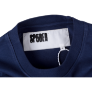 Close-up view of the SP5DER 5 Baby Tee neckline featuring the authentic brand neck label and white tag detail.
