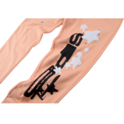 Sp5der Bellini sweatpants in peach featuring a black and white graphic print of the brand logo and star details.