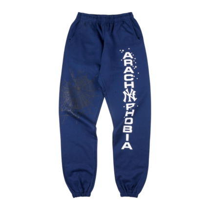 Front view of blue Sp5der Arach NY Phobia sweatpants with a bold white text graphic and arachnid motif design.