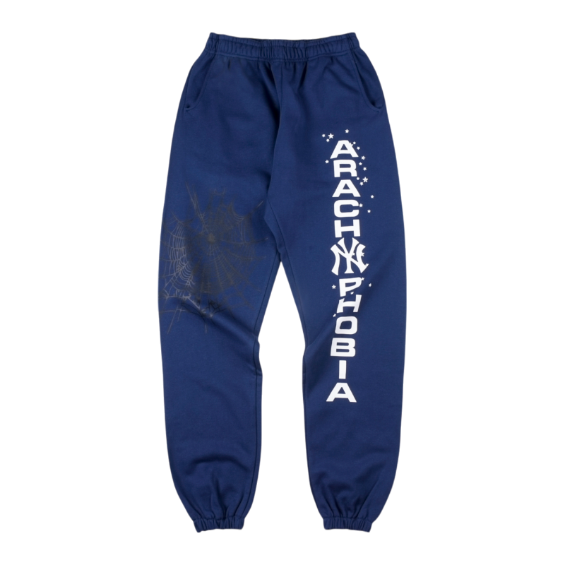 Front view of blue Sp5der Arach NY Phobia sweatpants with a bold white text graphic and arachnid motif design.