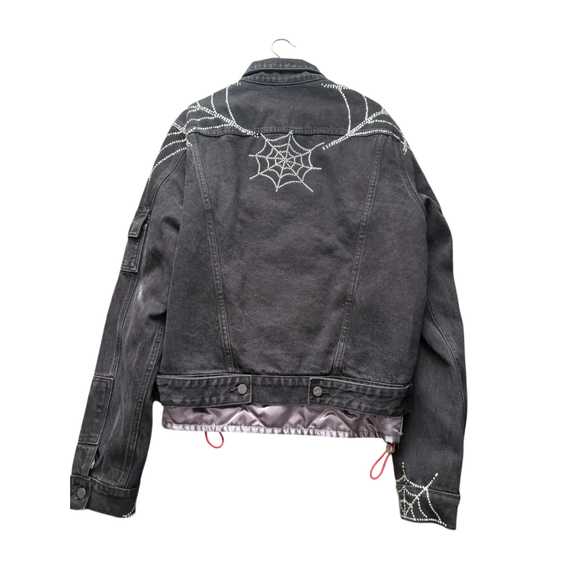 Black Sp5der Worldwide denim jacket featuring a signature rhinestone spider web motif on the back for streetwear style.