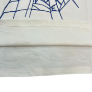 Close-up view of the Sp5der OG Web V2 T-shirt hem, highlighting the premium fabric and iconic spider web graphic detail.