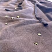 Close-up of the grey Sp5der x Cactus Jack Rodeo Short featuring metallic star embellishments and a drawstring waist.