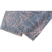 Sp5der AOP Vintage 501 denim jeans leg detail featuring a bold pink spiderweb all-over print on classic blue denim fabric.