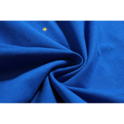 Close-up view of the royal blue moisture-wicking fabric on a Sp5der Summer Sports T-shirt with a small yellow star.