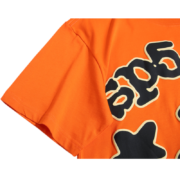 Close-up view of the vibrant orange Sp5der Worldwide Star Beluga T-Shirt showing detailed graphic print and fabric.