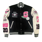 Front view of the SP5DER Division 5 varsity jacket in black and white with signature graphic patches and embroidery.
