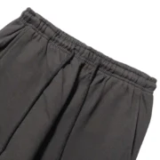 A close-up view of the jet-black elasticated waistband and drawstring on the premium Sp5der Beluga sweatpants.