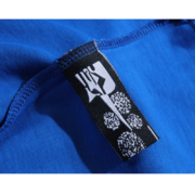 Close-up view of the Sp5der Worldwide Star blue T-shirt featuring an authentic branded neck tag for verification.