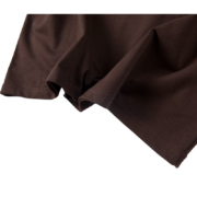 Close-up view of the premium brown cotton fabric used in the Sp5der 555 streetwear t-shirt construction and stitching.