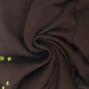 Close-up view of the premium fabric texture on the Sp5der 555 555 sweatpants with a subtle star motif design.