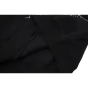 Close-up view of the black fabric and premium material quality on the iconic Sp5der P*NK black cotton blend hoodie.
