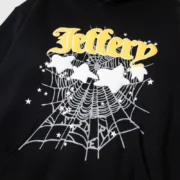 Sp5der Jeffery Black Graphic Hoodie featuring a signature spider web design with white stars and bold yellow lettering.