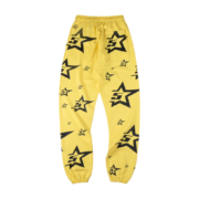 Sp5der 5Star sweatpants in a vibrant yellow colorway featuring a bold all-over black star graphic print for streetwear.