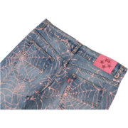 Close-up view of the Sp5der AOP Vintage 501 Denim Jeans featuring a signature pink spider web all-over print design.