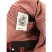 Close-up of the Sp5der 5ex AOP Denim Trucker Jacket interior brand label featuring the iconic web logo and branding.