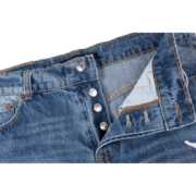 Detailed view of the Sp5der Vintage Web Jean Denim featuring premium distressed fabric and metal button closure.