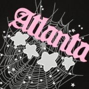 Sp5der Young Thug Atlanta t-shirt graphic showing pink text, spider web design, and stars on a black cotton background.