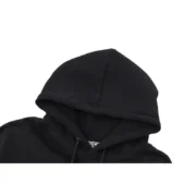 Detailed view of the hood on the premium black Sp5der Web Hoodie, featuring high-quality construction and design.