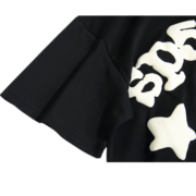 Close-up of the sleeve detail on the Sp5der Worldwide Star Beluga black T-shirt featuring a signature graphic design.