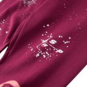 Close-up view of the branding and Nocturnal Highway graphic detail on maroon SP5DER cotton track pants for men.