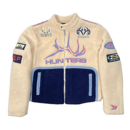 Front view of the beige and navy Sp5der Worldwide Hunters Sherpa Moto Jacket with branded patches and zipper.