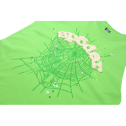 Close-up of the green Sp5der Wait Web t-shirt showing the detailed puff print spider web graphic and brand logo design.