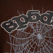 Brown Sp5der OG Web V2 hoodie featuring a high-quality signature spider web graphic print on the front chest area.