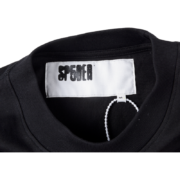 SP5DER x Cactus Jack x ComplexCon exclusive black tee neck label featuring branding and size tag details.