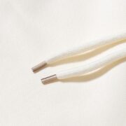 Close-up of the cream-colored drawstring detail on the Sp5der x Mariah the Scientist Scorpion Sweatpants for men.