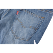 Close-up view of the back pocket detail on the blue Sp5der Vintage Web Jean Denim with signature branding tag.
