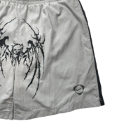 Grey elastic waist shorts featuring a detailed black Sp5der graphic print and Nike branding for a modern streetwear look.