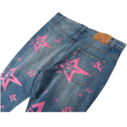 Back view of Sp5der 5Star Vintage 501 Denim jeans in blue with unique pink star print detail and leather branding.