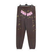 Brown Sp5der 555 555 sweatpants featuring a relaxed fit, pink graphic motif, and scattered yellow star print pattern.