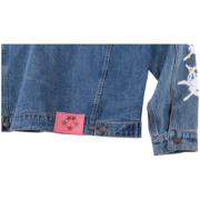 SP5DER Worldwide denim jacket back detail showing premium denim fabric and a signature pink branded star patch