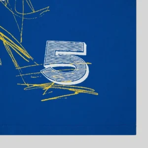 Close up of the Sp5der Vivienne Tee showing the blue fabric and detailed front graphic print with number five design.